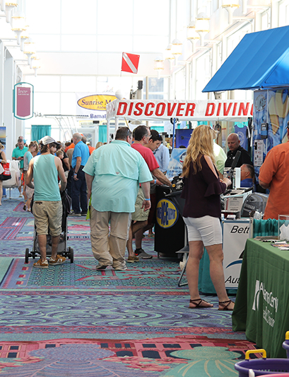 A group of visitors stops by the vendor stands during the Biloxi Boat Show